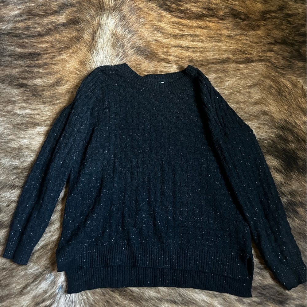 Maurice’s black sweater with gold thread